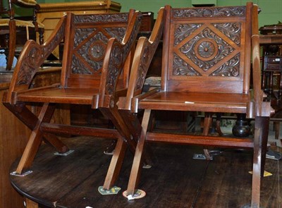 Lot 897 - Pair of late 19th century carved mahogany cross framed armchairs, width 62cm