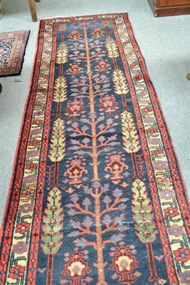 Lot 898 - North West Persian runner, the indigo field with columns of trees enclosed by narrow meandering...