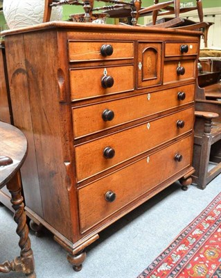 Lot 902 - Mid 19th century oak seven drawer chest with a central cupboard door, width 125cm