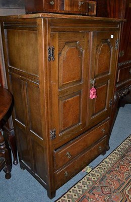 Lot 913 - A small cupboard with burr oak panel doors, width 76cm