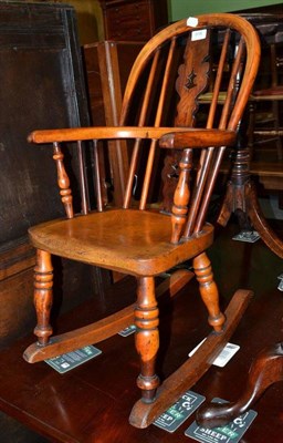 Lot 918 - A 19th century child's yew wood rocker, width 38cm