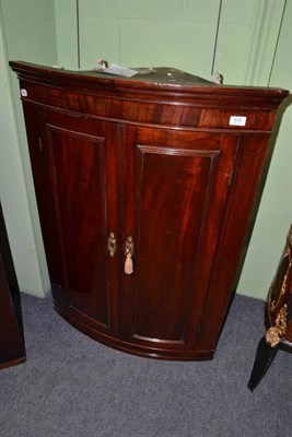 Lot 939 - Late George III mahogany bow fronted hanging corner cupboard, height 104cm