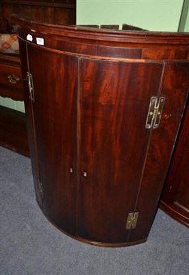 Lot 940 - George III mahogany bow fronted hanging corner cupboard, height 103cm