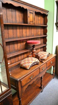 Lot 947 - An 18th century style oak dresser and rack, fitted three drawers and a pot board, width 152cm