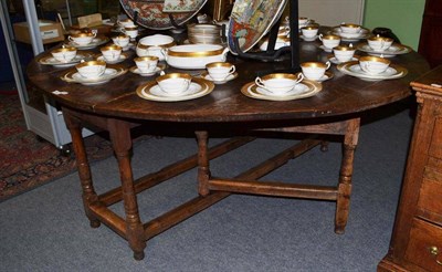 Lot 965 - A large 18th century oak gateleg table, the top in distressed condition, 198cm extended