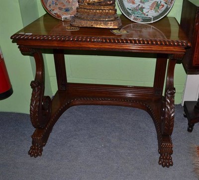 Lot 970 - A Goncalo Alves console table in the manner of Gillows on carved supports and claw feet, width...