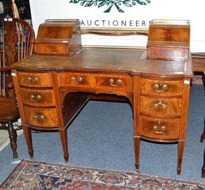 Lot 1001 - Edwardian mahogany and satinwood banded writing desk of serpentine shaped form, width 122cm