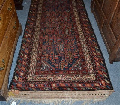 Lot 1010 - Narrow Malayir Runner, West Persia The mid indigo field with a boteh lattice enclosed by...