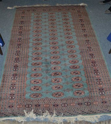 Lot 1014 - Lahore 'Bukhara' rug, Punjab, the sea green field with columns of guls enclosed by sunburst...