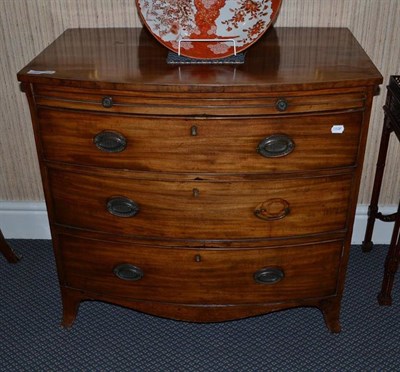 Lot 1320 - A Regency bow front mahogany chest with brushing slide, width 87cm