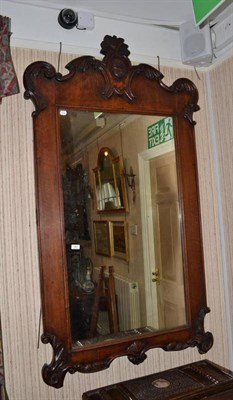 Lot 1367 - A 19th century walnut mirror with a carved pediment and frieze (previously a cheval mirror), height