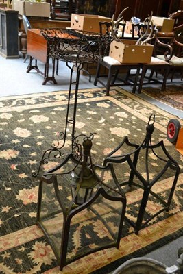 Lot 1499 - A pair of metal hanging lanterns; a decorative metal tripod planter; and a pair of decorative metal