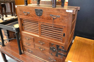 Lot 1501 - A Korean chest, with a long frieze drawer over a pair of louvred sliding doors, further drawers and