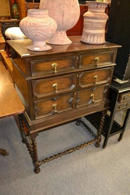 Lot 1509 - A 1920's oak three drawer chest on stand in 17th century style, width 75cm