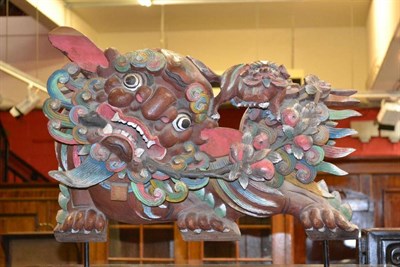 Lot 1511 - A 19th century Chinese carved, pierced and painted wood Temple ornament as a female fo dog with...