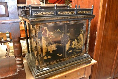 Lot 1519 - A Japanned and gilt decorated two door cabinet, width 70cm