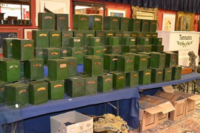 Lot 1553 - A set of 19th century green storage tins with painted labels, assorted sizes, the largest tin 17 cm