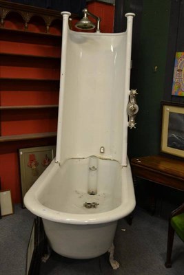 Lot 1565 - Late Victorian/Edwardian cast iron bath on claw feet with shower enclosure