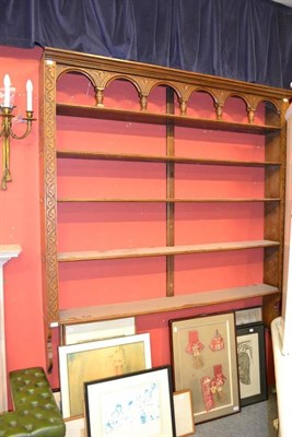 Lot 1566 - A large oak set of hanging shelves with carved stiles, height 180cm