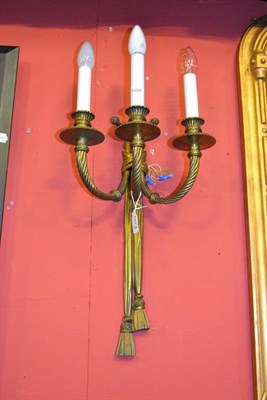 Lot 1574 - A set of three gilt metal three branch light fittings with rope swags, height 48cm