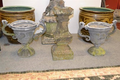 Lot 1582 - A pair of lead twin handled urns, height 40cm