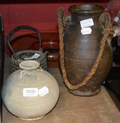 Lot 1605 - A Japanese cast iron tea kettle, 19th century, with knobbly decoration, 21cm high; a Thai Swankhlok