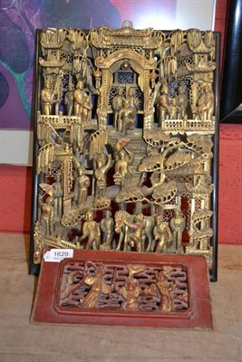 Lot 1629 - A Chinese carved wood panel, early 20th century, figures with umbrellas, monkey wrench etc in a...