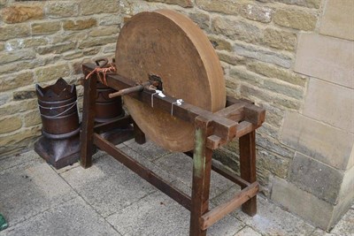 Lot 1637 - Stone circular grindstone on wooden stand