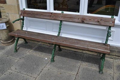 Lot 1641 - A green painted metal garden bench with three wooden slats, length 197cm