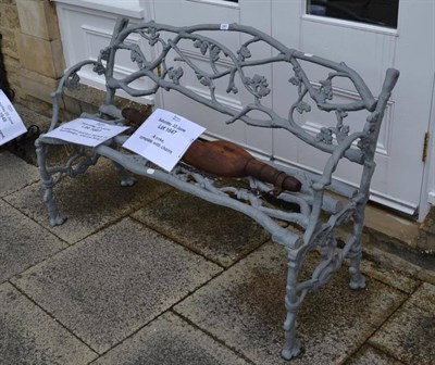 Lot 1661 - A cast iron garden bench of leaf design, 130 cm long