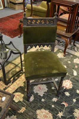 Lot 1689 - In the manner of Pugin, a Gothic revival carved oak chair with stylised terminals and back