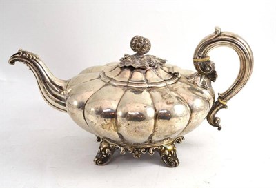 Lot 26 - Silver melon decorated teapot on four legs, London 1871