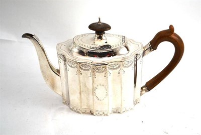 Lot 38 - A George III silver teapot with bright cut decoration, London 1793