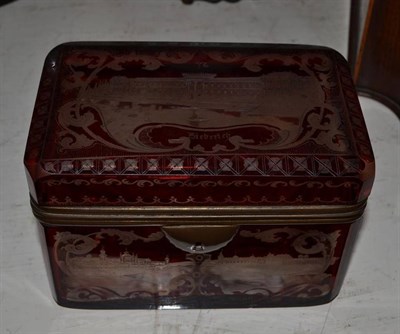 Lot 88 - A Bohemian metal mounted ruby overlay glass casket engraved with named views, 14cm