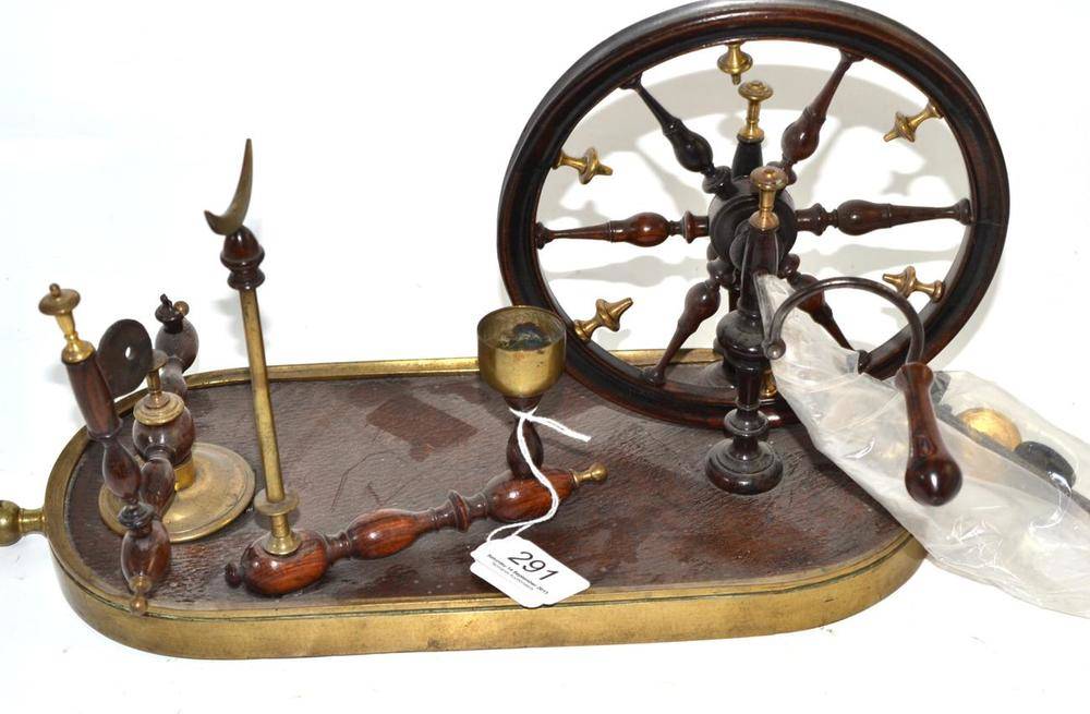 Lot 291 - A 19th century French turned wood, leather and brass mounted yarn winder, with six spoke wheel with