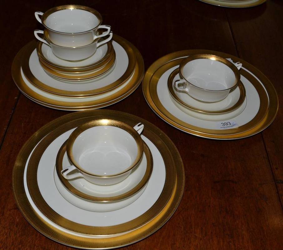 Lot 393 - Royal Worcester Durham pattern dinner service for twelve in cream and gold, comprising dinner...