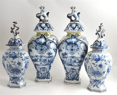 Lot 2 - A pair of Delft vases with lids and a pair of Delft vases with associated lids