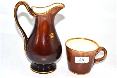 Lot 28 - A Rockingham treacle glazed twist handle cup and a similar jug (2)