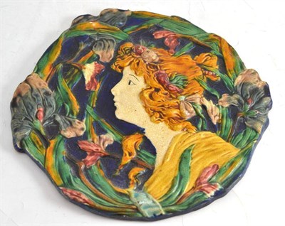 Lot 44 - Art Nouveau majolica plaque, moulded with the profile of a young maiden