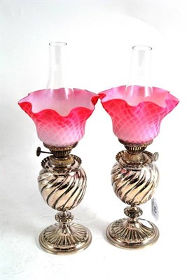 Lot 63 - Pair of silver plated oil lamps/night lights with pink shades