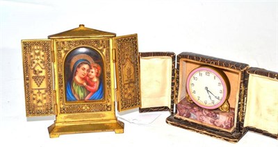 Lot 69 - A gilt metal triptych religious plaque and a Swiss pink enamel clock on marble base (cased)