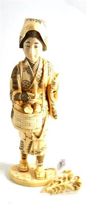 Lot 89 - A Japanese carved walrus and elephant tusk composite figure of a countrywoman, circa 1910, standing