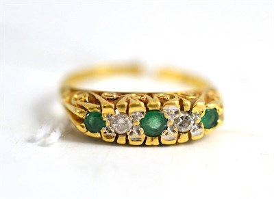Lot 94 - An 18ct gold emerald and diamond five stone ring