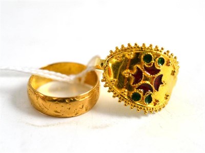Lot 108 - A 22ct gold red and green enamelled ring and a 22ct gold patterned band ring