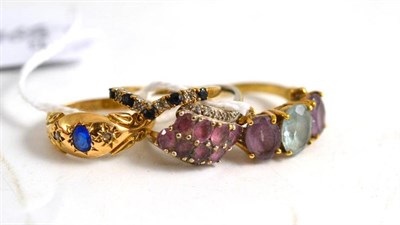 Lot 110 - A 9ct gold sapphire and diamond wishbone ring, an 18ct gold three stone ring, a 9ct gold topaz...