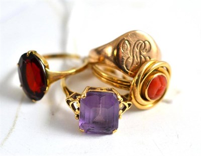 Lot 118 - A coral set ring, a signet ring, a garnet ring and a 9ct gold amethyst ring