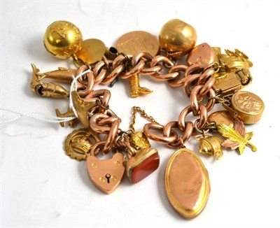 Lot 123 - A charm bracelet hung with assorted charms