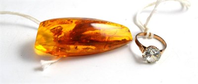 Lot 132 - An amber brooch and a white stone ring