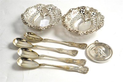 Lot 133 - A pair of silver pierced dishes, a silver medallion and a set of four Irish silver mustard spoons