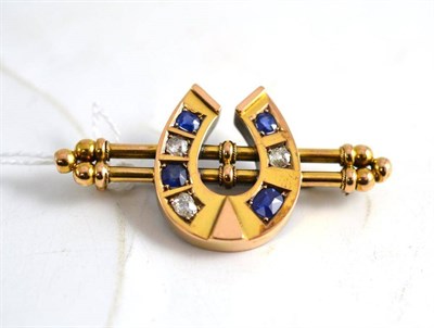 Lot 144 - A horseshoe brooch set with diamonds and blue stones